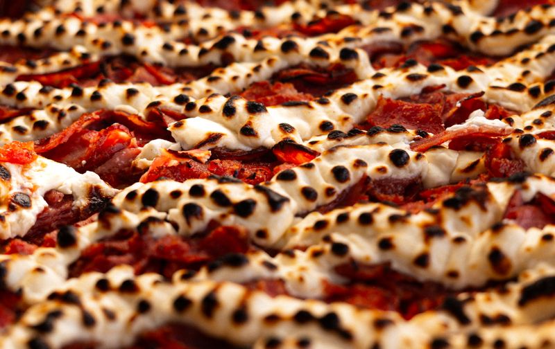 Sausage and basil via 313 pizza with crispy Detroit-style crust
